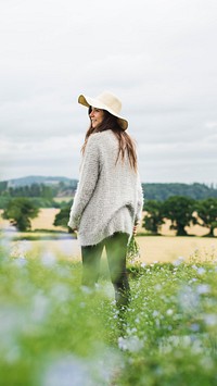 Spring phone wallpaper background, woman in flower field