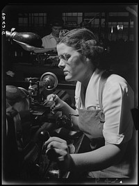 Production. Machine guns of various calibers. Agnes Mahan, bench lathe operator at a large Eastern firearms plant, makes oil drills for .50- caliber machine gun barrels. Many women workers are employed in this plant, producing essential weapons for the armed forces. Sourced from the Library of Congress.