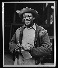 African Americans speed war work for Tennessee Valley Authority. Lincoln C. Johnson, sub-labor foreman at Wilson Dam, is in charge of an expert crew responsible for unloading carbide drums and having them on hand for reloading. Speedy work saves TVA money by avoiding demurrage on railway cars. He is vice-president of the Hot Carriers' local union and in the last few months has been business agent. Sourced from the Library of Congress.