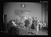 "You Can't Do Business With Hitler." Rehearsing for the radio show "You Can't Do Business With Hitler" are Colonel Charles Ferris, Doris McWhirt, and Virginia Moore at the microphone. In the control room with script and talk-back microphone in hand is Frank Telford, whod directs each production of the series. The programs are written and produced by the radio section of the Office of War Information (OWI). Sourced from the Library of Congress.