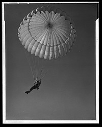 Fort Benning. Parachute troops. Look at that boy come, riding a chute like an oldtimer. A student paratrooper at Fort Benning, Georgia has wind currents to think about, and he has his mind on the spot where he wants to land. He's learning to make the kind of a landfall he wants. Sourced from the Library of Congress.