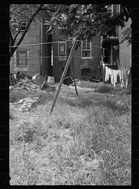 [Untitled photo, possibly related to: Backyard near Capitol, Washington, D.C.  children have just discovered the cameraman and are concerned at his presence]. Sourced from the Library of Congress.