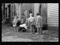 Poor children playing on sidewalk, Georgetown, Washington, D.C.. Sourced from the Library of Congress.