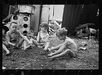 [Untitled photo, possibly related to: Slum children at play, Washington, D.C. Children in their backyard near the Capitol. This area inhabited by both black and white]. Sourced from the Library of Congress.