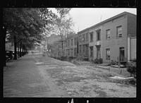 Section of Massachusetts Avenue showing block of shabby houses with outside toilets and water supply, Washington, D.C.. Sourced from the Library of Congress.