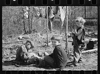 Three of the family of nine living in field in rough board covering built on old Ford truck chassis on U.S. Route 70, between Camden and Bruceton, Tennessee. Their water supply was an open creek running near state highway. Sourced from the Library of Congress.