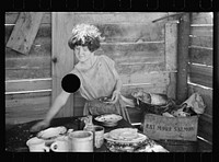 [Untitled photo, possibly related to: Twelve-year old girl of family of nine, cooking meal in rude, open lean-to near hut, Tennessee]. Sourced from the Library of Congress.