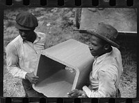 Workmen unloading tile pipe, Greenbelt, Maryland. Sourced from the Library of Congress.