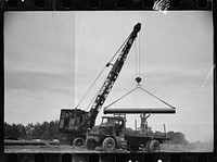 Unloading pipe with crane, Greenbelt, Maryland. Sourced from the Library of Congress.
