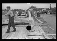 [Untitled photo, possibly related to: Loading wall of prefabricated house onto truck, Roanoke Farms, North Carolina]. Sourced from the Library of Congress.
