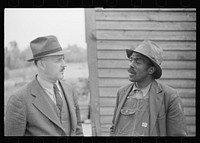 Nat Williamson and E.H. Anderson, F.S.A. official. Williamson was the first  in the U.S. to receive a loan under the tenant purchase program. Guilford County, North Carolina. Sourced from the Library of Congress.