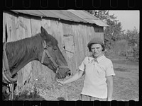 Girl who operates large farm with help of her sister and a rehabilitation loan, Coffey County, Kansas. Sourced from the Library of Congress.