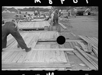 [Untitled photo, possibly related to: Carpenter working on gable of prefabricated house, Roanoke Farms, North Carolina]. Sourced from the Library of Congress.