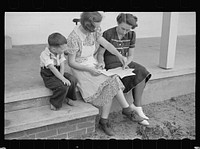 Home supervisor showing Mrs. Pope how to keep account book, Irwinville Farms, Georgia. Sourced from the Library of Congress.