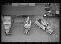 Trucks loading at farm implement warehouse, Minneapolis, Minnesota. Sourced from the Library of Congress.