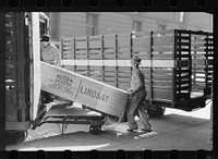 Loading tank onto truck at farm machinery warehouse, Minneapolis, Minnesota. Sourced from the Library of Congress.