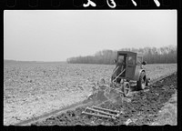 Plowing and harrowing in tractor with cab, Grundy County, Iowa. Sourced from the Library of Congress.