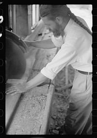 Member of House of David using circular saw, Benton Harbor, Michigan. Sourced from the Library of Congress.