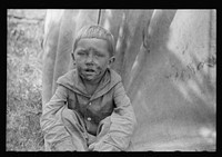 [Untitled photo, possibly related to: Migrant child in front of tent home, Berrien County, Mich.]. Sourced from the Library of Congress.