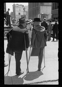 Two one-legged men outside church on Sunday morning, St. Louis, Missouri. Sourced from the Library of Congress.