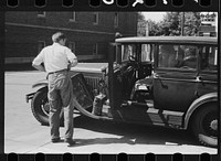 [Untitled photo, possibly related to: Auto of migrant fruit worker at gas station, Sturgeon Bay, Wisconsin]. Sourced from the Library of Congress.