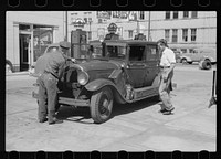 Auto of migrant fruit worker at gas station, Sturgeon Bay, Wisconsin. Sourced from the Library of Congress.
