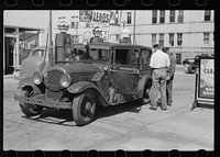 [Untitled photo, possibly related to: Auto of migrant fruit worker at gas station, Sturgeon Bay, Wisconsin]. Sourced from the Library of Congress.