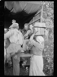 Cranberry pickers getting into truck that will carry them back to Philadelphia, Burlington County, New Jersey. Sourced from the Library of Congress.