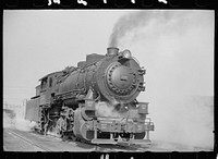 Locomotive in railroad yards along river, St. Louis, Missouri. Sourced from the Library of Congress.