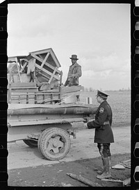 State highway officials moving sharecroppers away from roadside to area between the levee and the Mississippi River, New Madrid County, Missouri. Sourced from the Library of Congress.