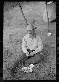 [Untitled photo, possibly related to: Cowboy eating in Three Circle roundup camp, Powder River County, Montana]. Sourced from the Library of Congress.