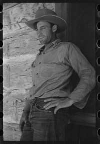 [Untitled photo, possibly related to: Cowboy in front of bunkhouse, Quarter Circle U Ranch, Big Horn County, Montana]. Sourced from the Library of Congress.