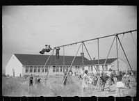 [Untitled photo, possibly related to: Children of resettlement families playing in the schoolyard, community building, San Luis Valley Farms, Alamosa, Colorado]. Sourced from the Library of Congress.