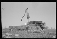 Pump, oilcan cut in half used as trough, Nashville, Brown County, Indiana. Sourced from the Library of Congress.