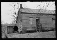 [Untitled photo, possibly related to: Resettlement Administration representative at door of rehabilitation client's house, Jackson County, Ohio]. Sourced from the Library of Congress.