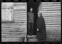 [Untitled photo, possibly related to: Resettlement Administration representative at door of rehabilitation client's house, Jackson County, Ohio]. Sourced from the Library of Congress.