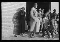 [Untitled photo, possibly related to: Lined up and waiting for a meal in the camp for  flood refugees at Forrest City, Arkansas]. Sourced from the Library of Congress.