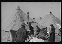 [Untitled photo, possibly related to: A  flood refugee family who, with their rescued household goods have moved into the camp at Forrest City, Arkansas]. Sourced from the Library of Congress.