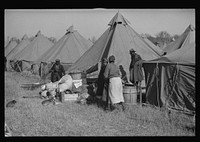 A  flood refugee family who, with their rescued household goods have moved into the camp at Forrest City, Arkansas. Sourced from the Library of Congress.