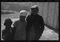 [Untitled photo, possibly related to:  flood refugees wearing identification tags after registering in the camp at Forrest City, Arkansas]. Sourced from the Library of Congress.