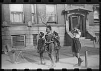 [Untitled photo, possibly related to: Children in front of apartment buildings in one of the better neighborhoods in the Black Belt, Chicago, Illinois]. Sourced from the Library of Congress.