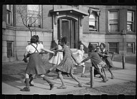 [Untitled photo, possibly related to: Children playing "ring around a rosie" in one of the better neighborhoods of the Black Belt, Chicago, Illinois]. Sourced from the Library of Congress.