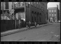 [Untitled photo, possibly related to: es in front of their home, Black Belt, Chicago, Illinois]. Sourced from the Library of Congress.