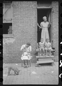 [Untitled photo, possibly related to:  family in front of their alley dwelling. The older woman is a cleaning woman in the U.S. government. Washington, D.C.]. Sourced from the Library of Congress.