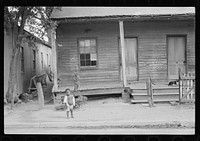  child in front of badly rundown house, Natchez, Mississippi. Sourced from the Library of Congress.