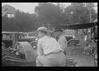 Attendants at farm machinery display at county fair, central Ohio. Sourced from the Library of Congress.