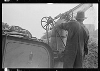 Adjusting straw stocker on grain separator, central Ohio. Sourced from the Library of Congress.