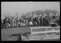 [Untitled photo, possibly related to: Refugees lined up at meal time in the camp for white flood refugees in Forest City, Arkansas]. Sourced from the Library of Congress.
