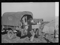 Unloading the household goods of a family who is being moved into the camp for white flood refugees at Forrest City, Arkansas. Sourced from the Library of Congress.