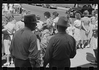 Waiting for the Fourth of July parade to pass, Watertown, Wisconsin. Sourced from the Library of Congress.